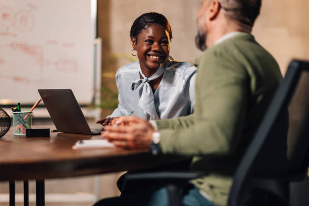 istock Smiling interracial coworkers discussing paperwork and project at office 2139295354