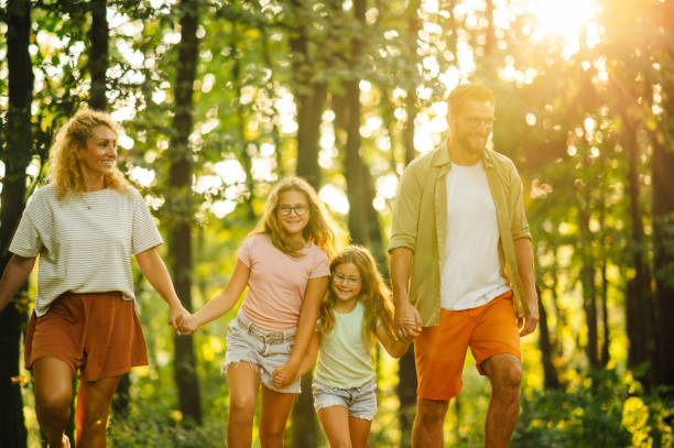 istock An affectionate family is holding hands and hiking in forest. 2139295356