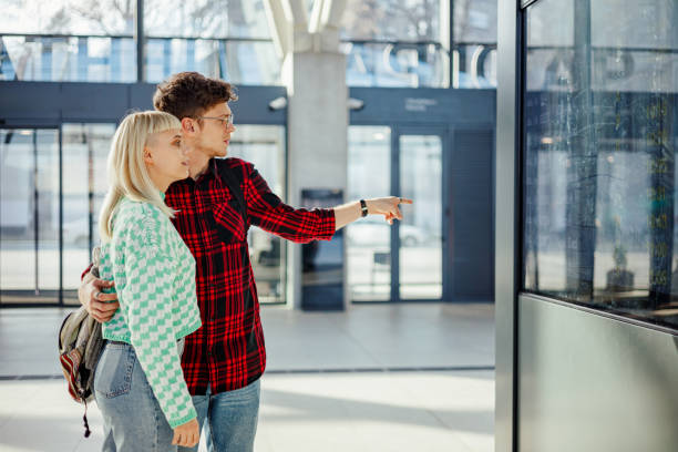 istock Young travelers are looking at timetable at train station and pointing. 2139295361