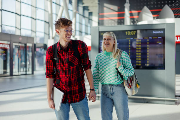 istock Happy digital nomads holding hands and going on a journey by train. 2139295362