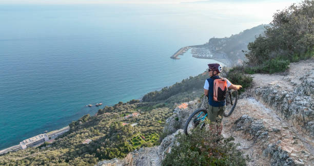 istock Aerial view of mountain biker above sea 2139359618