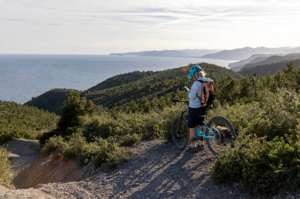 istock Mature mountain biker uses mobile phone 2139365335