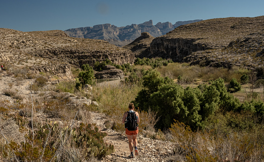 Woman Hikes Next To The Rio Grand Along The Hot Springs Trail in Big Bend
