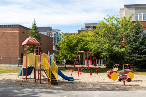 istock Children playground in park near school yard. Summer break. 2139390636