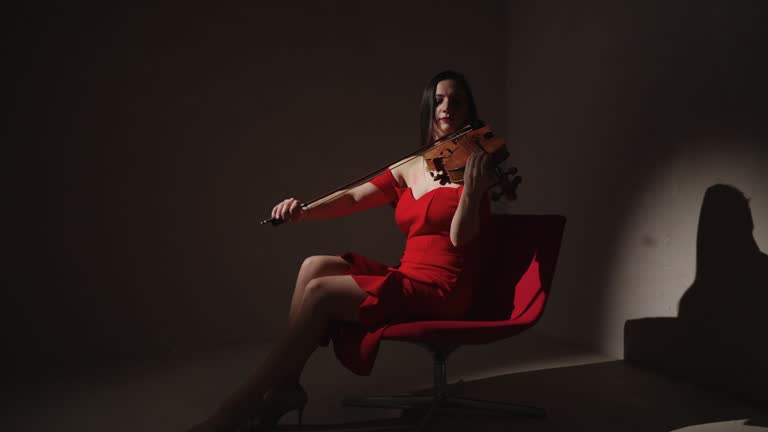 Woman Fiddler Playing Classic Melody In Studio With Flying Snowflakes, Winter Fairytale