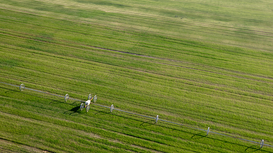 Irrigation equipment in cut alfalfa field seen from aerial viewpoint in Menifee southern California United States