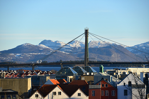 Panoramic teleshot of downtown Stavanger with the Stavanger City Bridge (Norwegian: Stavanger Bybru) in the background on a sunny afternoon in Stavanger, Norway. It is a cable-stayed bridge in the city of Stavanger which is the largest in Stavanger Municipality in Rogaland county, Norway.