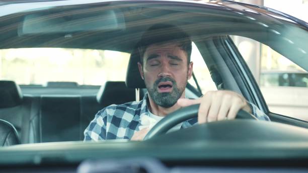 istock Sick guy has a runny nose while sitting in the car. Slow motion 2139441396