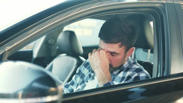 istock Tired man feeling stressed while sitting in the car. Slow motion 2139441940