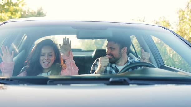 istock Happy couple making party in the car while driving. Slow motion 2139441942