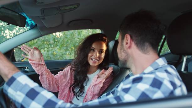 istock Positive couple talking while sitting in the car. Slow motion 2139441944