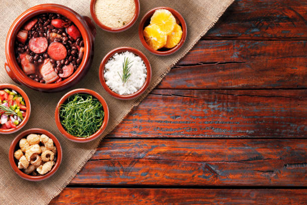 istock Brazilian feijoada, traditional food from Brazil cuisine, on ceramic casserole bowl, over rustic wooden table 2139507111