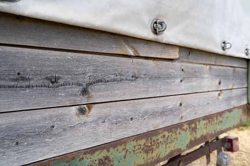 Close up of a aged tractor trailer with wooden panels