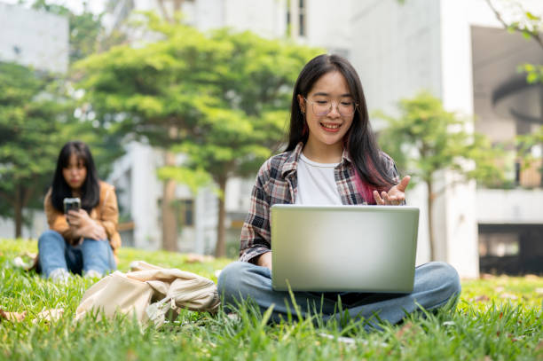 istock A young college student is having a video call meeting on her laptop while sitting in a park. 2139582512