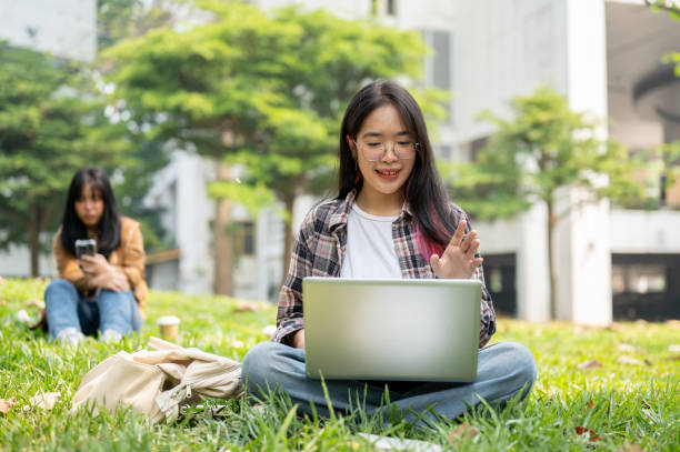 istock A young college student is having a video call meeting on her laptop while sitting in a park. 2139582513