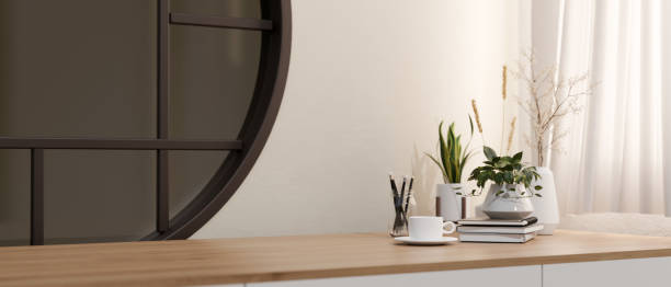 istock A minimalist wooden table with a space for display products against a white wall with a round window. 2139584599