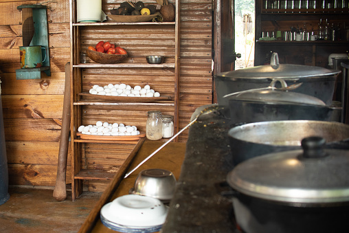 Cooking in rustic wood-fired kitchen in the countryside