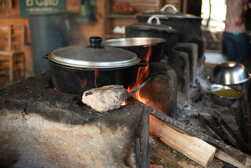 Cooking in rustic wood-fired kitchen in the countryside