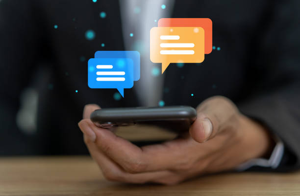 istock Human hand using smartphone typing Live chat chatting and social network concepts, chatting conversation working at home in chat box icons pop up. Social media marketing technology concept 2139639805