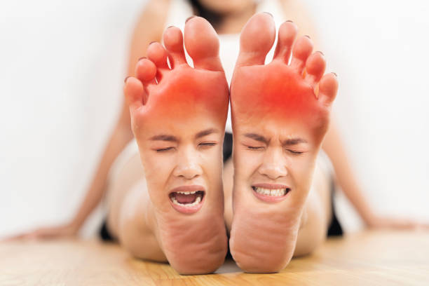 A woman's feet are shown with a red mark on them. The woman is in a pose that looks like she is in pain