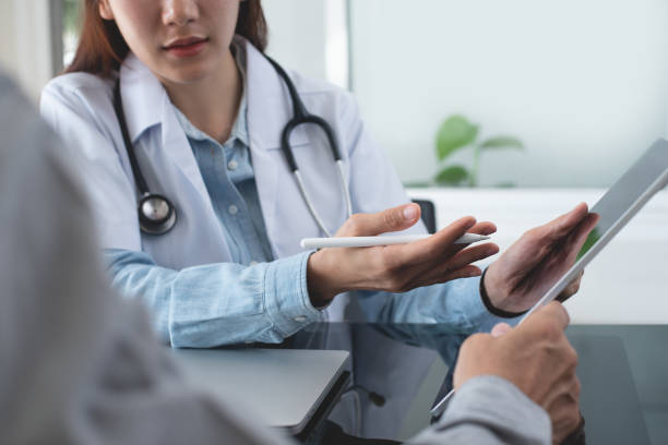 istock Female asian doctor showing digital tablet screen to patient, explaining checkup result, medical screening, giving consultation on appointment at medical clinic, close up 2139711223