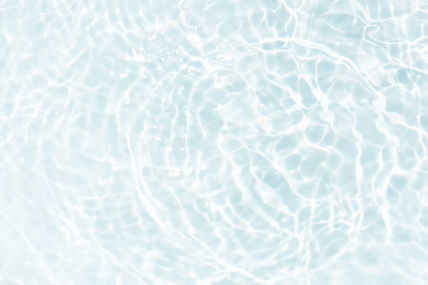 istock Bluewater waves on the surface ripples blurred. Defocus blurred transparent blue colored clear calm water surface texture with splash and bubbles. Water waves with shining pattern texture background. 2139716912