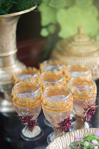 a glass filled with water as equipment for the traditional Javanese siraman ceremony before marriage