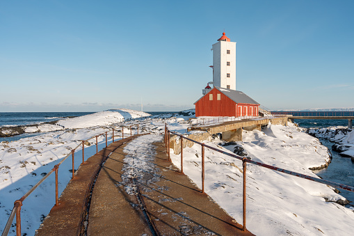 Kjolnes Lighthouse by the Barents Sea on a sunny winter day in March, Berlevåg Norway
