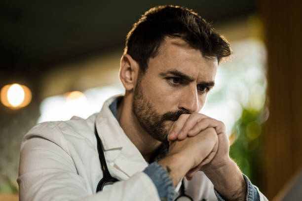 istock Close-up of pensive male doctor thinking while working in his office. 2139785755