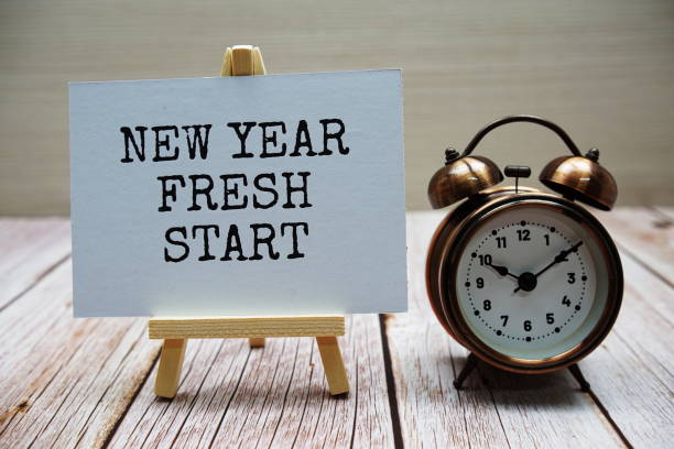 istock New year fresh start word with alarm clock on wooden background 2139793137