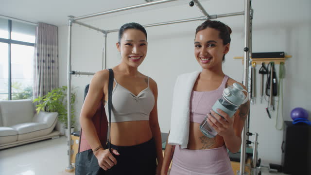 Portrait of Two Asian Female Athletes after Workout Indoors