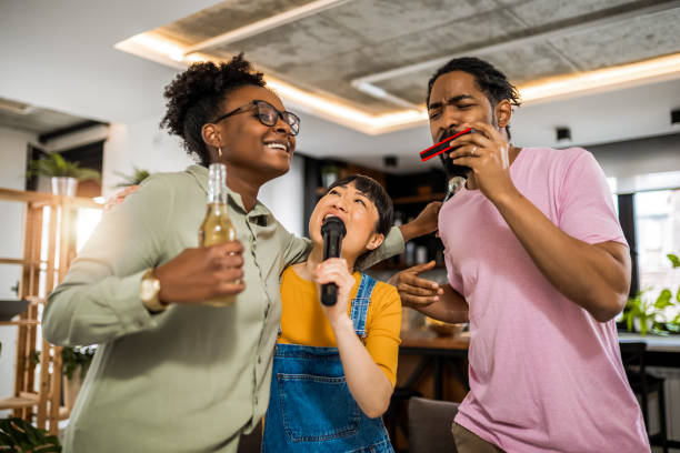 istock Multiracial group of friends having karaoke night. 2139793225