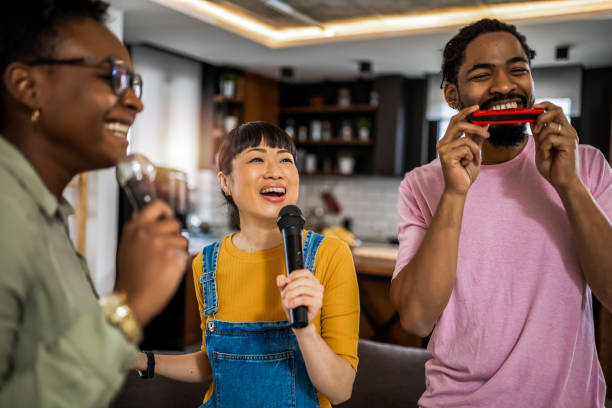 istock Multiracial group of friends having karaoke night. 2139793227