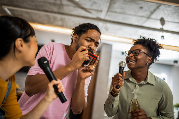 istock Multiracial group of friends having karaoke night. 2139793228