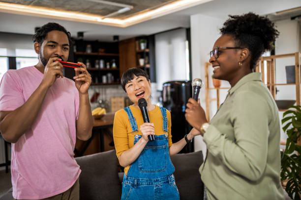 istock Multiracial group of friends having karaoke night. 2139793242