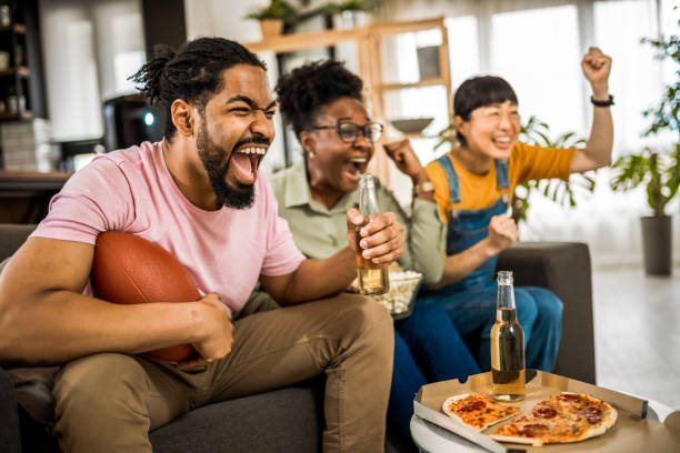 istock Multiracial group of friends watching rugby. 2139797364