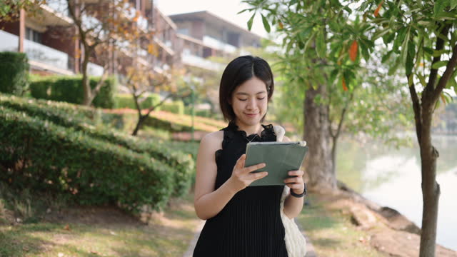 Asian people using digital tablet Forecasting real estate and retirement fund for calculating tax with data
