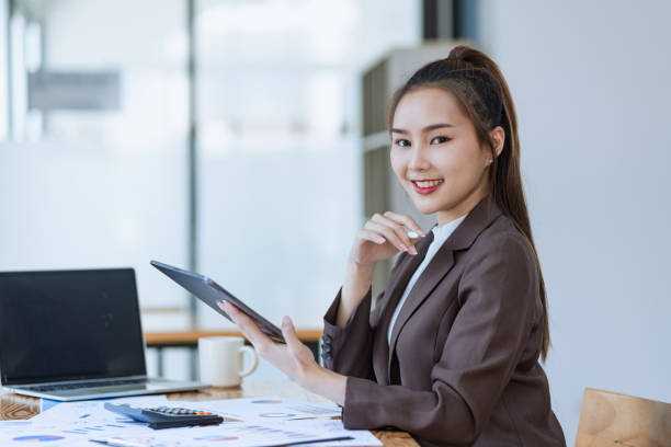 istock Asian businesswoman working with laptop computer and documents placed at the office. 2139839577