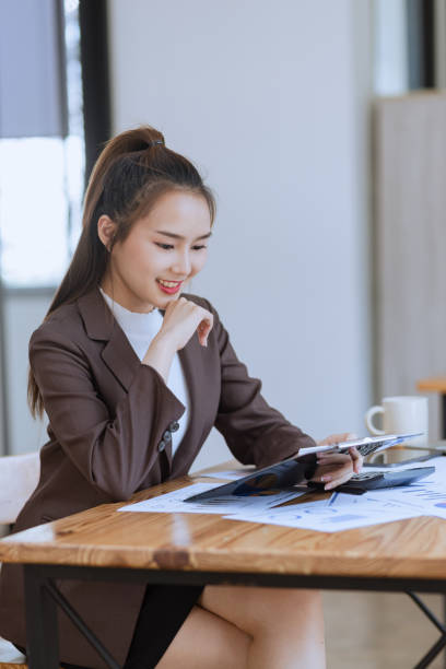 istock Asian businesswoman working with laptop computer and documents placed at the office. 2139839579