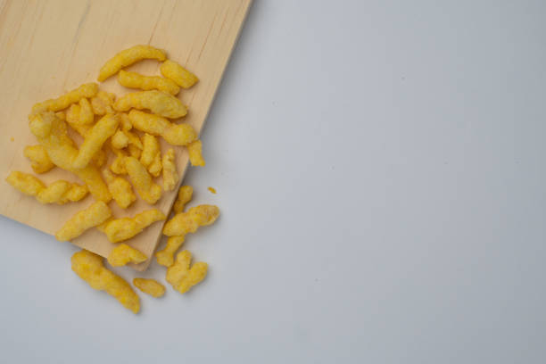istock corn chips snack on wooden cutting board isolated on white background. 2139875951