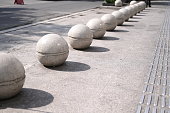Pedestrian boundary stone ball with road