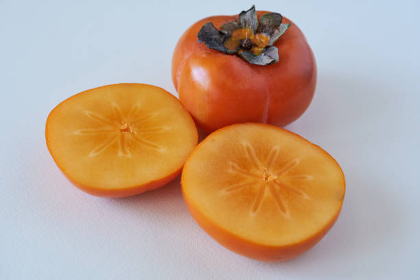 istock Ripe persimmon fruit on a white background close-up 2139910778
