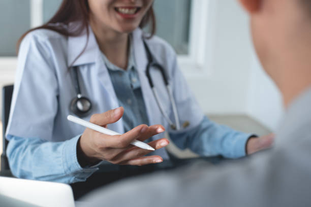 istock Female asian smiling doctor using digital tablet computer,  explaining to patient for checkup result, medical screening, giving consultation on appointment at medical clinic, close up 2139916640