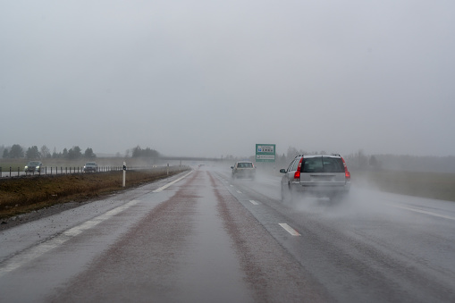 Gray misty weather with water on the road outside Orebro Sweden March 16 2024
