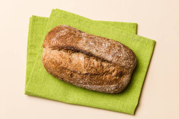 istock Fresh Homemade Whole Wheat Bread. bread on napkin on rustic background, fresh bread top view 2139930583