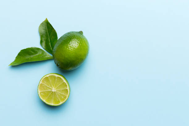 istock Lime fruits with green leaf and cut in half slice isolated on white background. Top view. Flat lay with copy space 2139930587