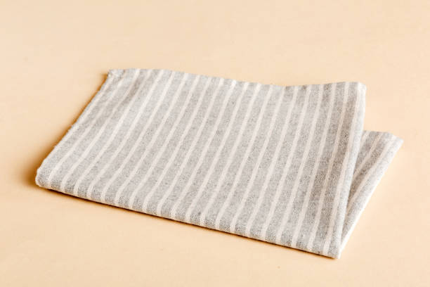 istock top view with gray kitchen napkin isolated on table background. Folded cloth for mockup with copy space, Flat lay. Minimal style 2139931162