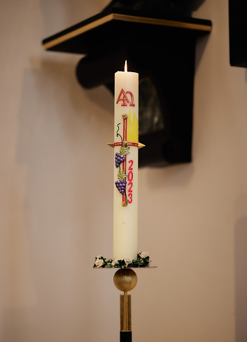 Moos, Germany – February 11, 2024: A Candle on a baptism ceremony in a church in Bavaria Germany