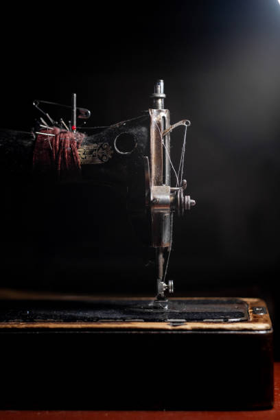 istock Old sewing machine stands on the table at home ready to work and sew. 2139958746