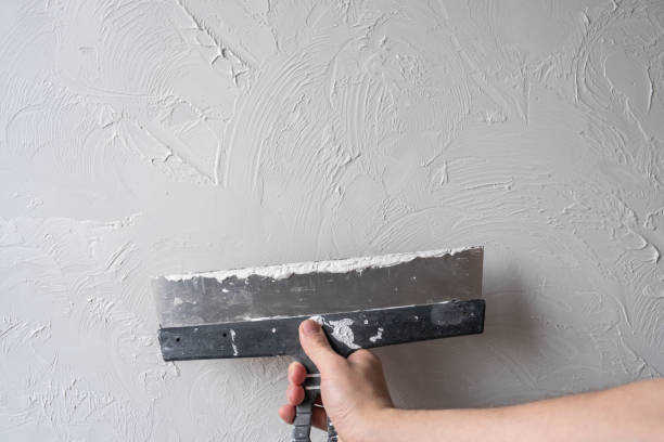 istock Applying decorative putty. White abstract texture of surface covered with putty 2139963528